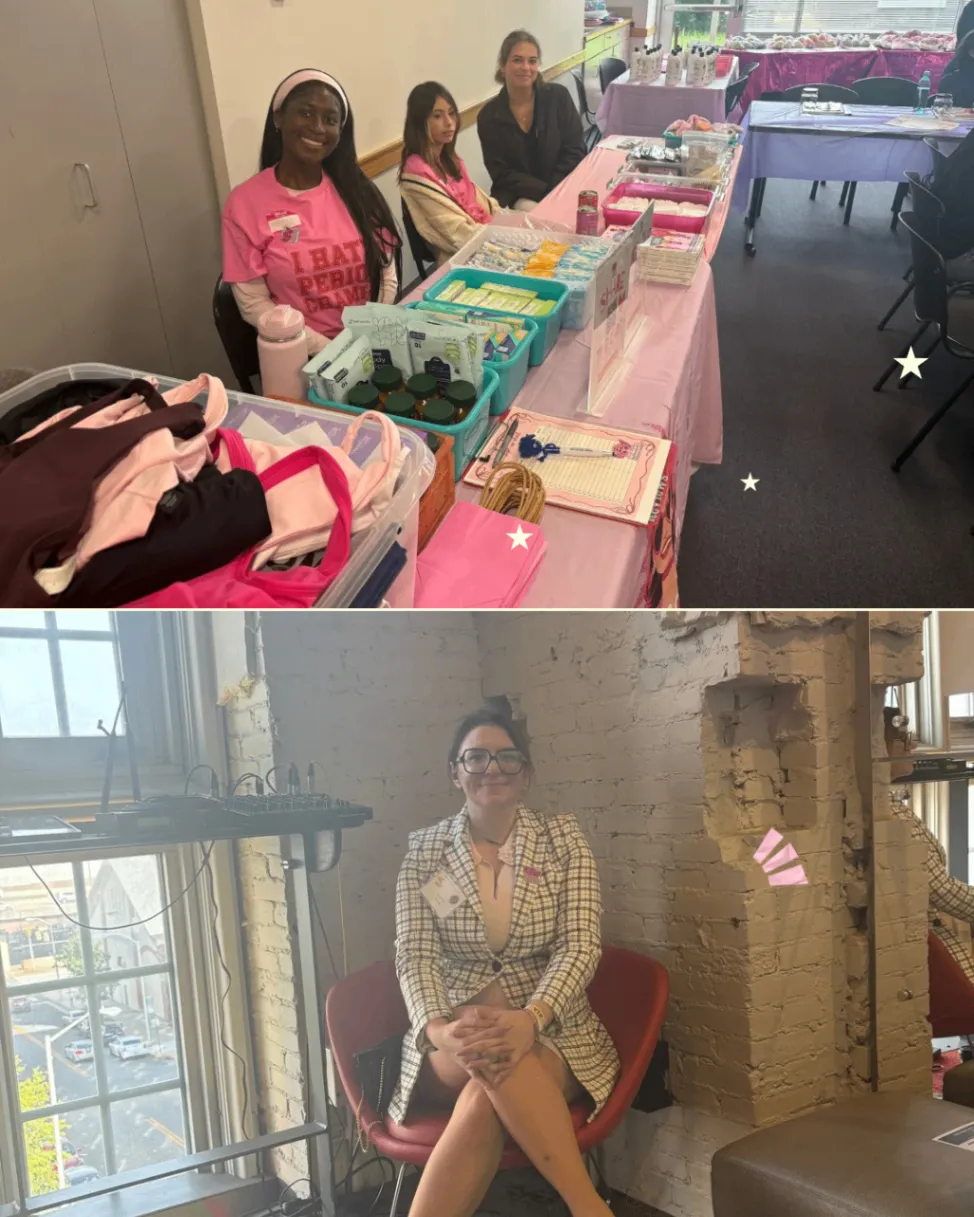 Volunteers seated at a table with menstrual products and supplies prepared for an event.
